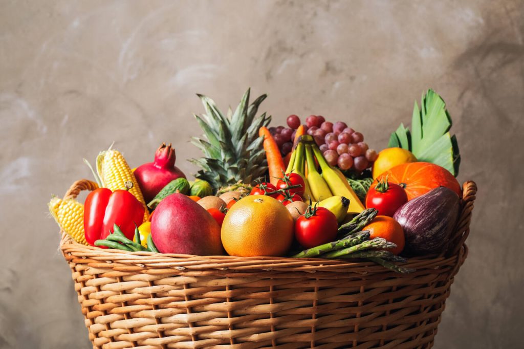 Fresh organic fruit and vegetables in a fruit basket
