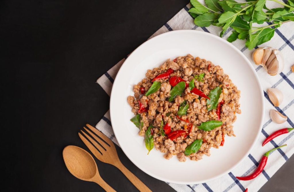 A heaping portion of stir-fried Thai holy basil and pork (pad gaprao) served with rice and a fried egg
