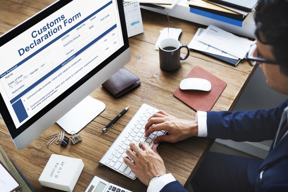 An official fills out customs forms